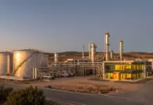 Serbia, MOL Sign Shareholders’ Deal to Decide NIS Management Industrial processing plant with large storage tanks and complex piping at sunset.
